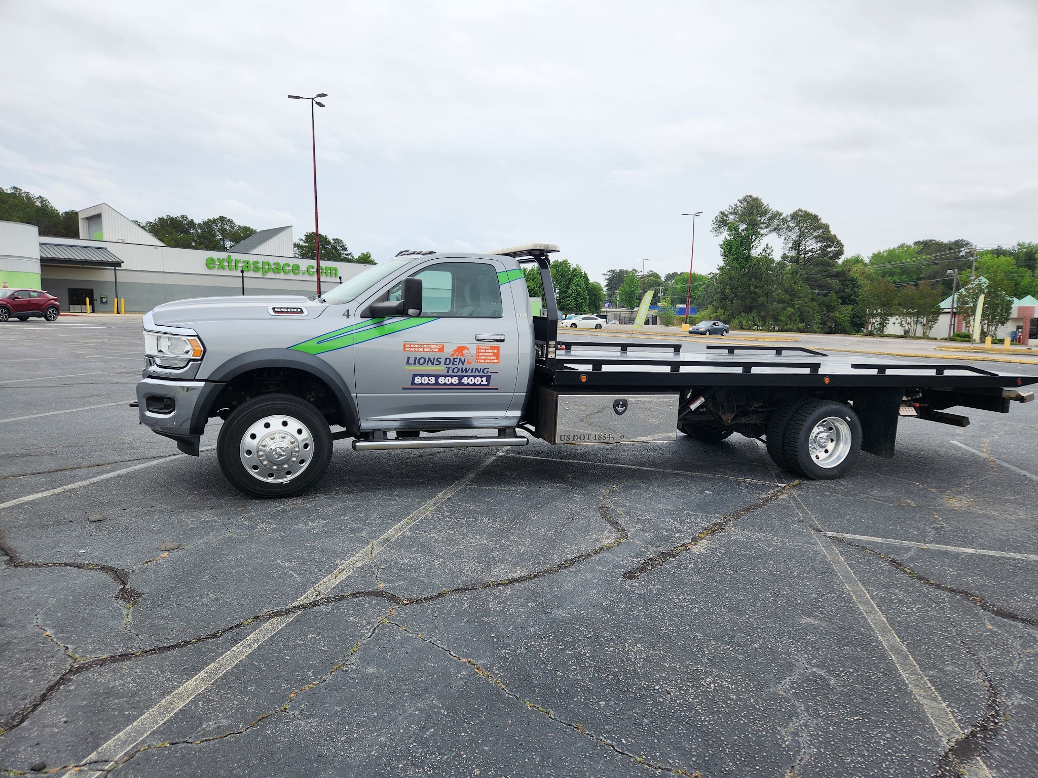 Our flatbed tow truck parked in a lot