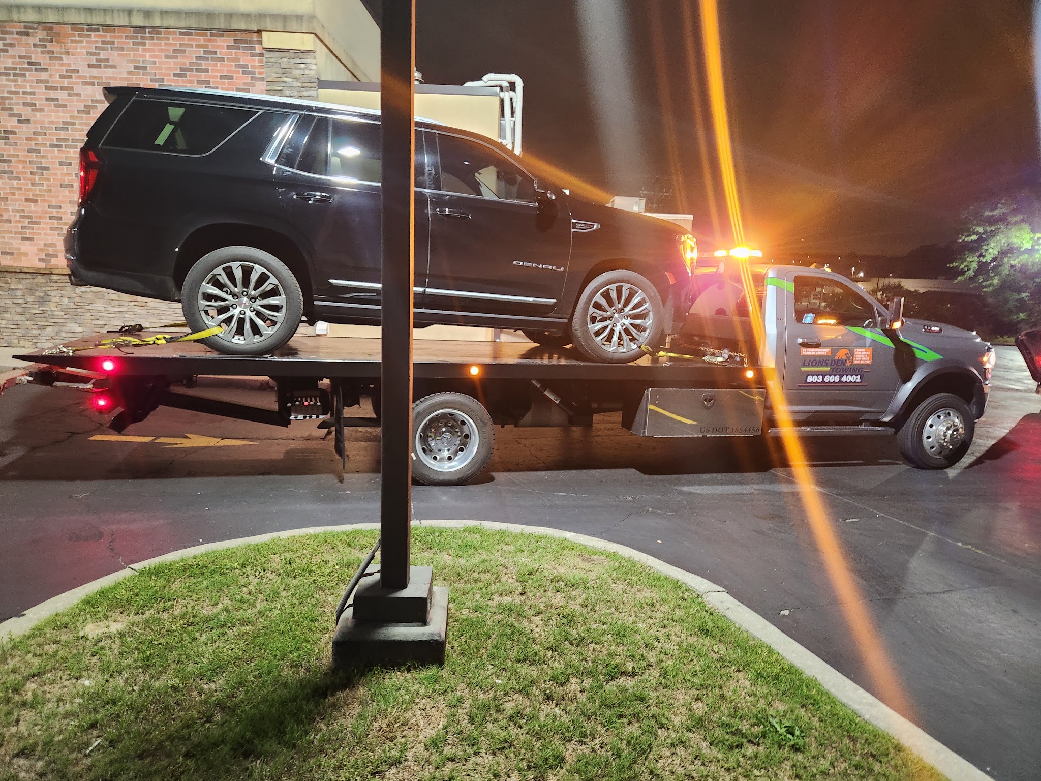An SUV on our flatbed at night