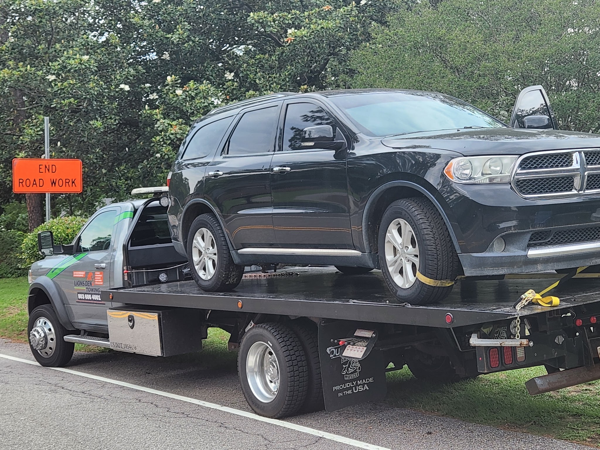 A black Dodge Durango strapped down on our flatbed