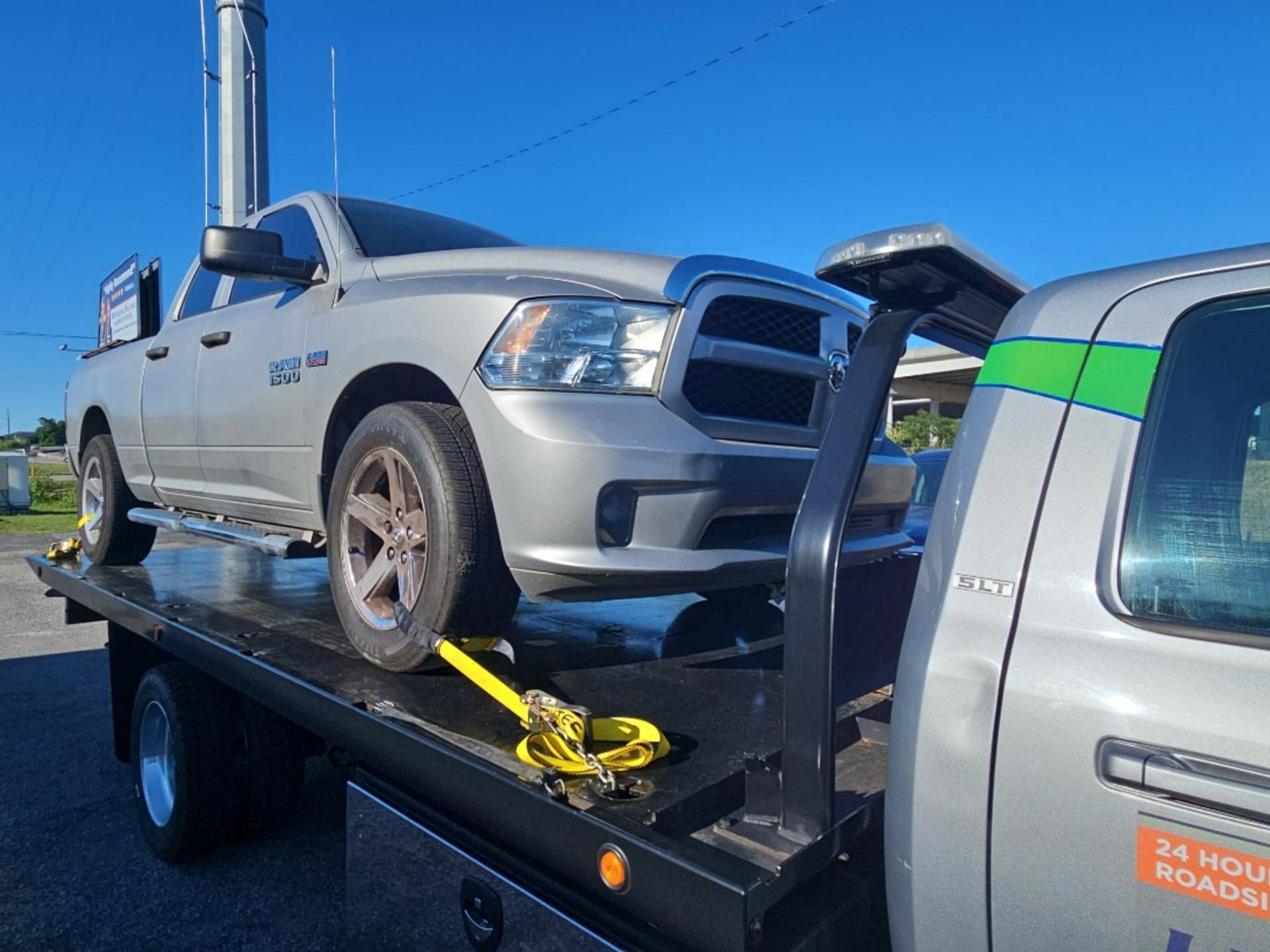 A silver pickup loaded on our flatbed