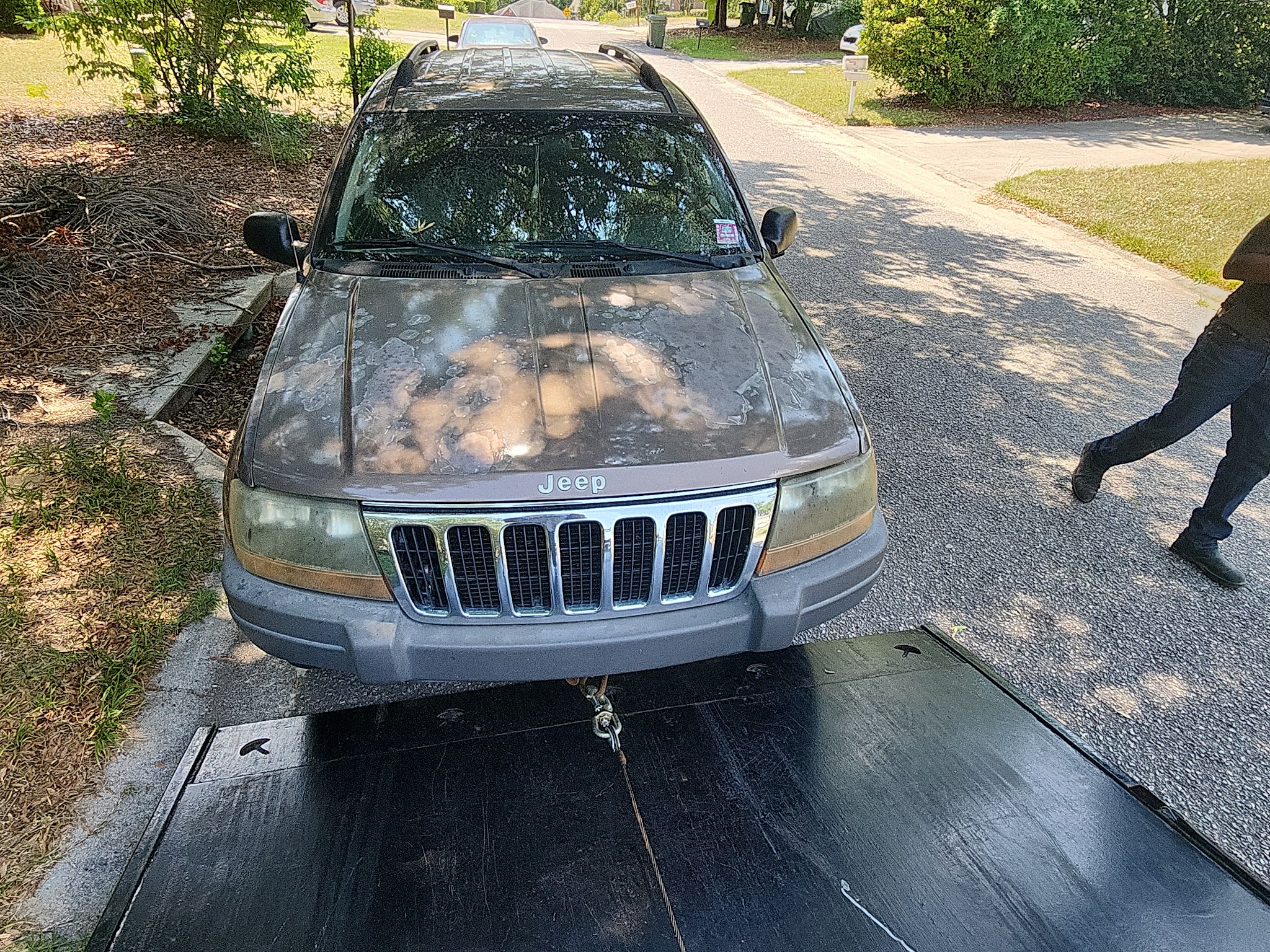 A Jeep Grand Cherokee being winched onto the bed